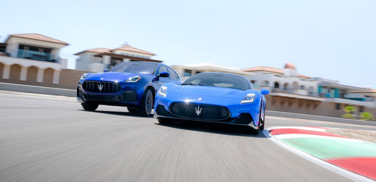 Two blue Maserati's on a race track