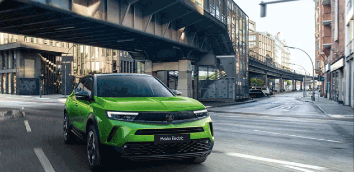 Green Vauxhall Mokka in a city road